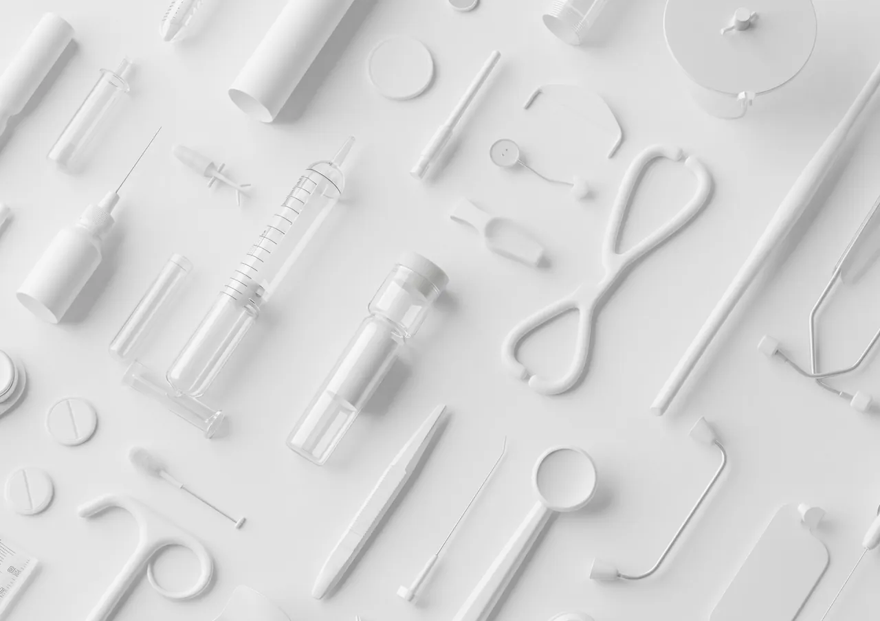 Weisse medizinische Instrumente mit Stethoskop, Spritzen und Dentalspiegel auf hellem Hintergrund.